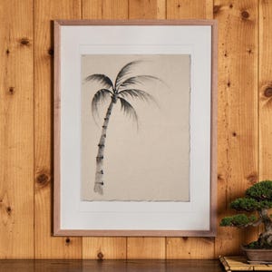 Lone Palm Tree Ink Style print in a Red Oak frame with a white mat, hanging above the cabinet in a tea room.