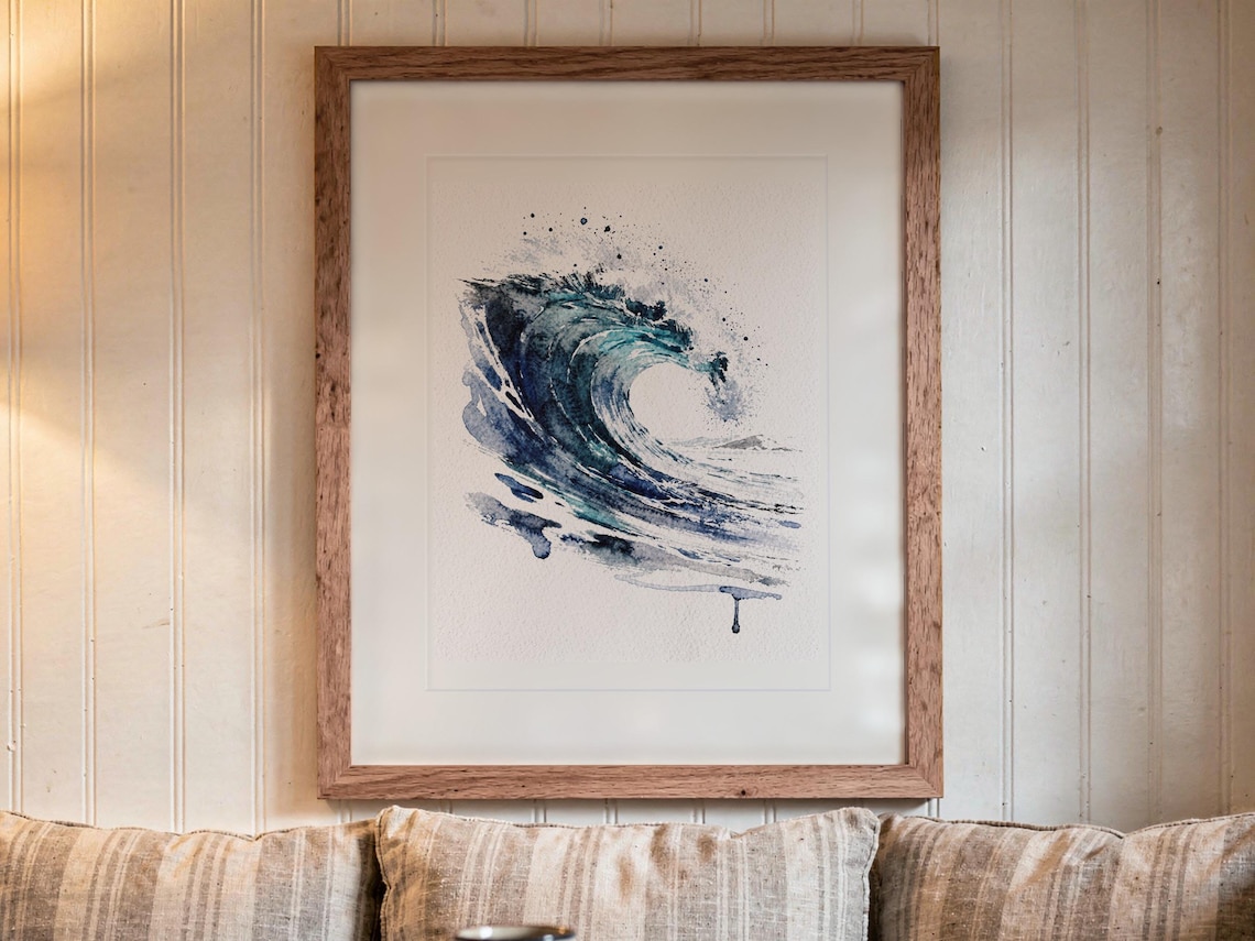 Glass Curl Wave Watercolor print in a Red Oak frame with a white mat, hanging above the bench in a breakfast nook.
