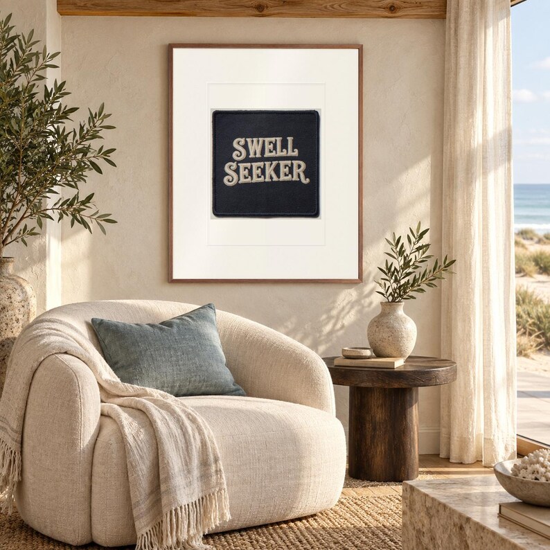 Swell Seeker Patch print in a Red Oak frame with a white mat in a light-filled coastal sitting room.