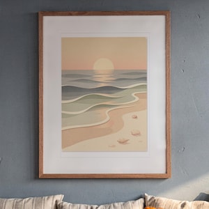 May include: A framed wall art print featuring a stylized beach scene with a pale sun setting over layered ocean waves in shades of blue, green, and beige. The sandy shore includes small, simple shapes representing seashells.