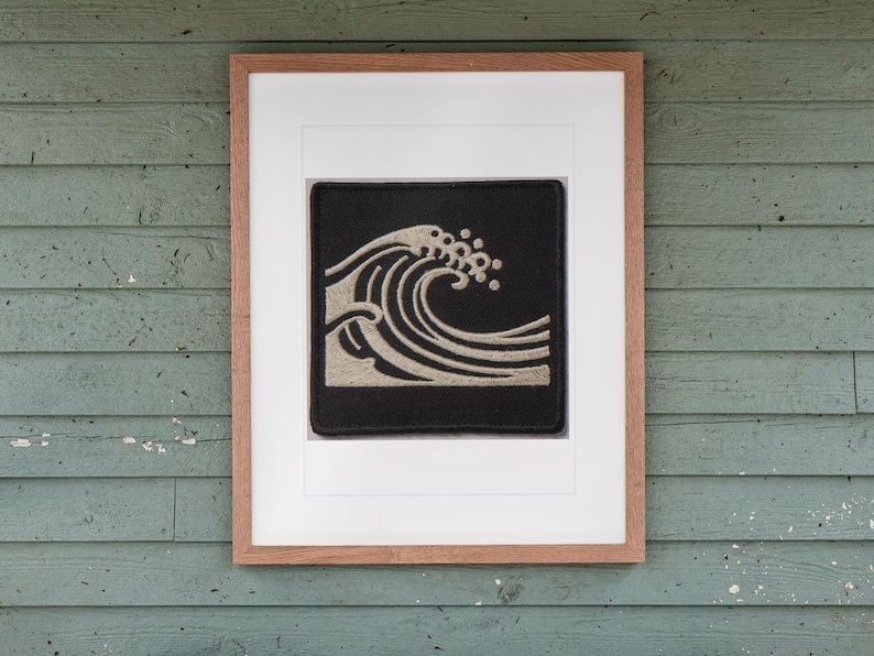 Wave Patch print in a Red Oak frame with a white mat, hanging above the bench in a screened beach porch.