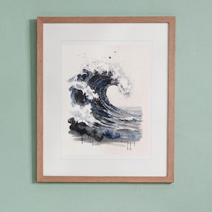 May include: A framed watercolor painting of a large, dark blue ocean wave crashing. The artwork features white sea foam and splashes against a light background, enclosed in a simple, light-toned wooden frame with a white mat border.