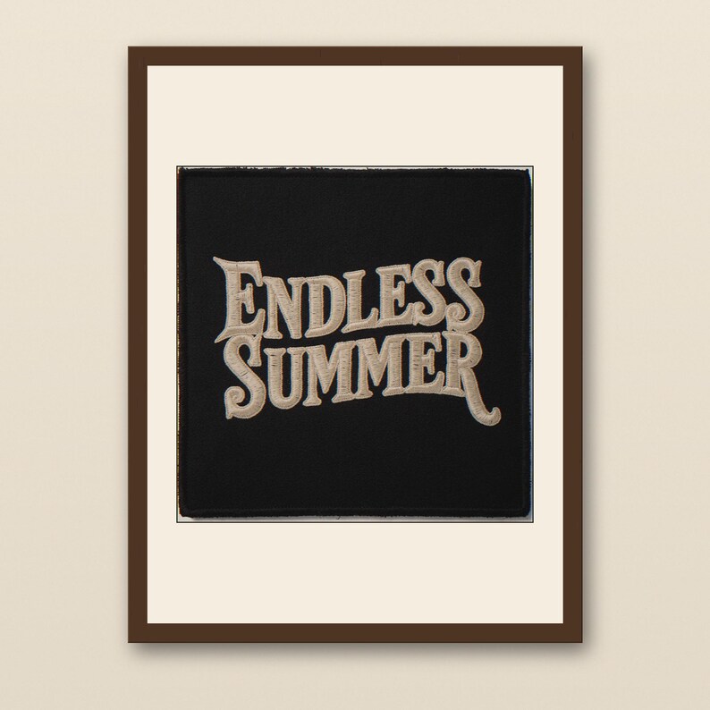 Endless Summer Embroidered Patch Print - walnut framed art print with cream mat on plaster wall