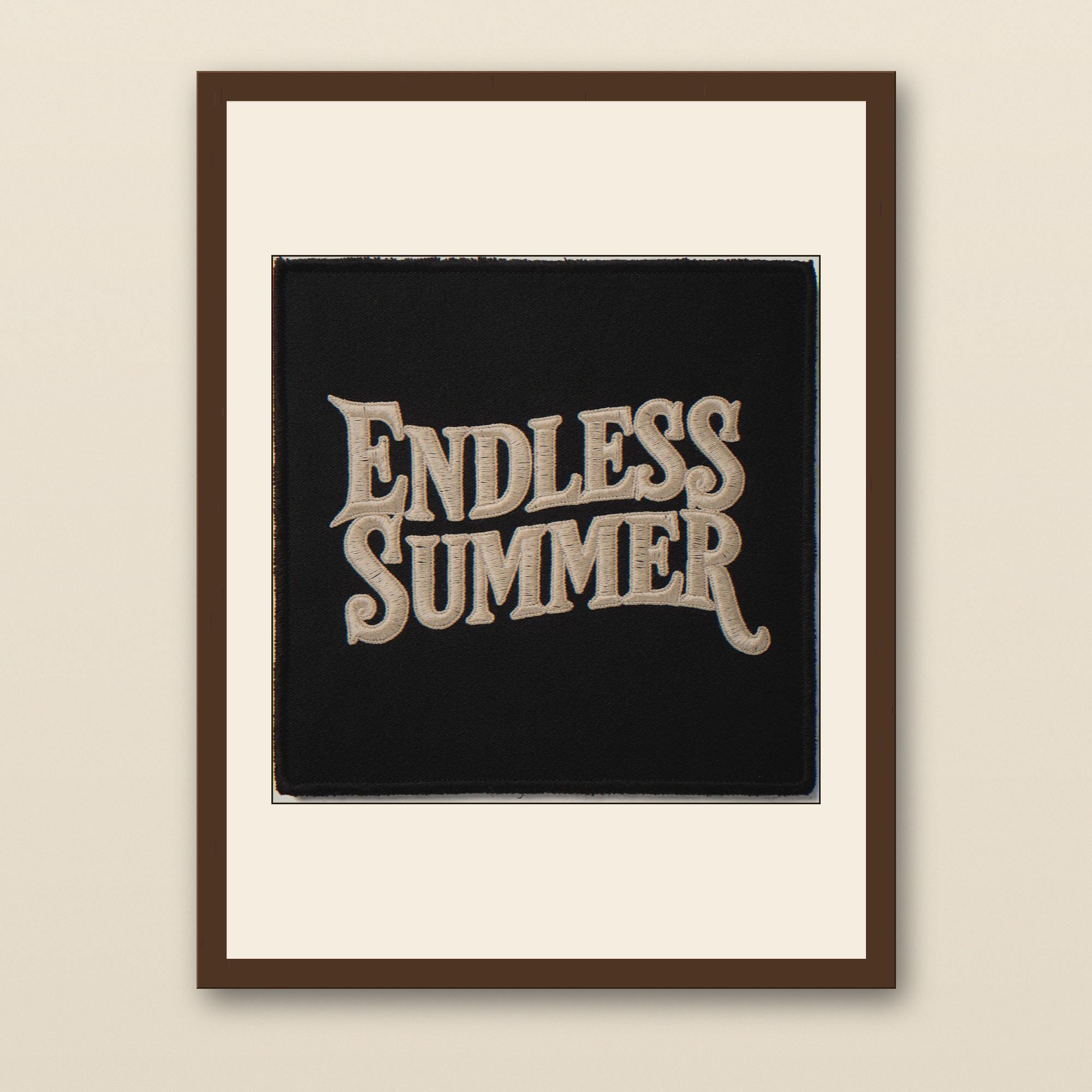 Endless Summer Embroidered Patch Print - walnut framed art print with cream mat on plaster wall