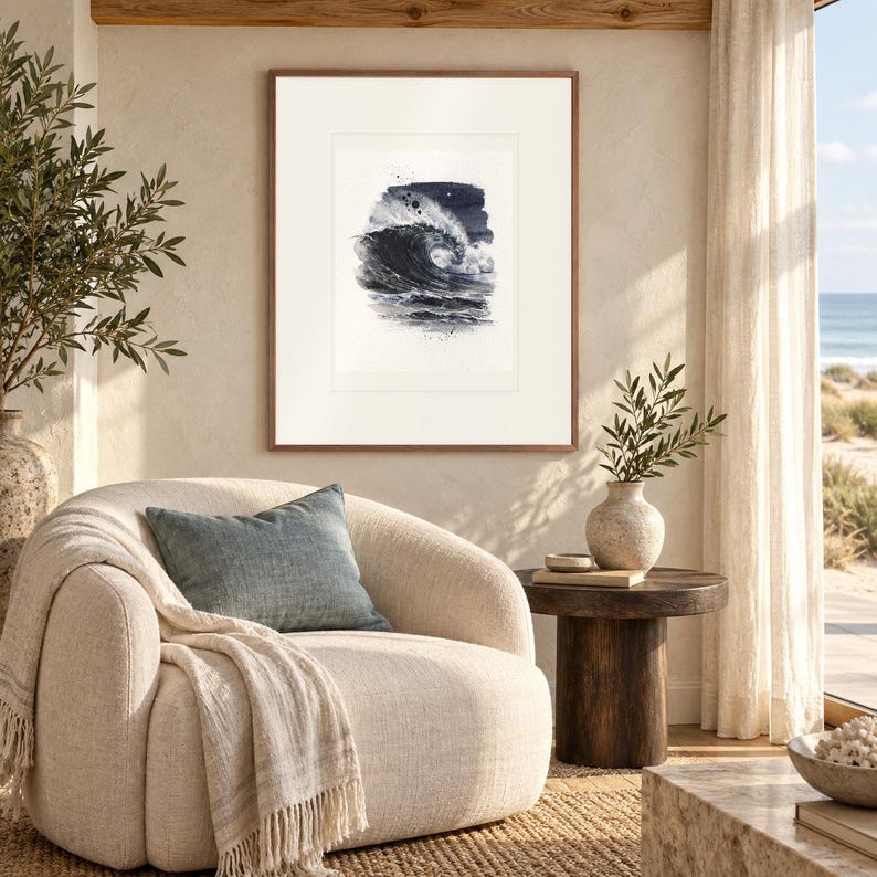 Moonlit Wave Watercolor print in a Red Oak frame with a white mat in a light-filled coastal sitting room.