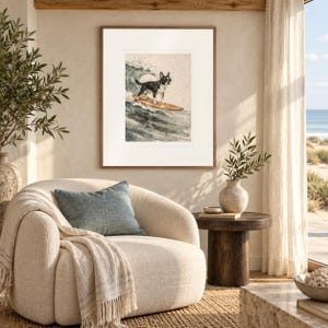 Boston Terrier Surfing print in a Red Oak frame with a white mat in a light-filled coastal sitting room.