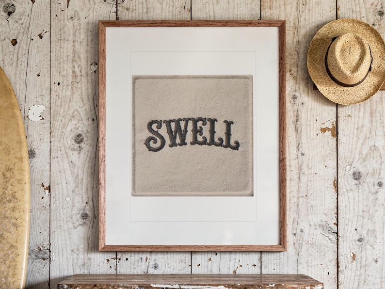 Swell Patch print in a Red Oak frame with a white mat, hanging above the dresser in a surf shack bedroom.