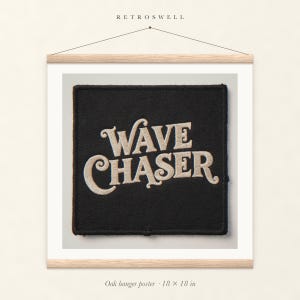 Wave Chaser Patch oak hanger poster, 18 by 18 inches, with natural wood rails and a hanging cord.