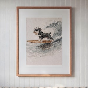 Miniature Schnauzer Surfing printable art, shown printed in a Red Oak frame with a white mat, hanging above the bench in a breakfast nook.