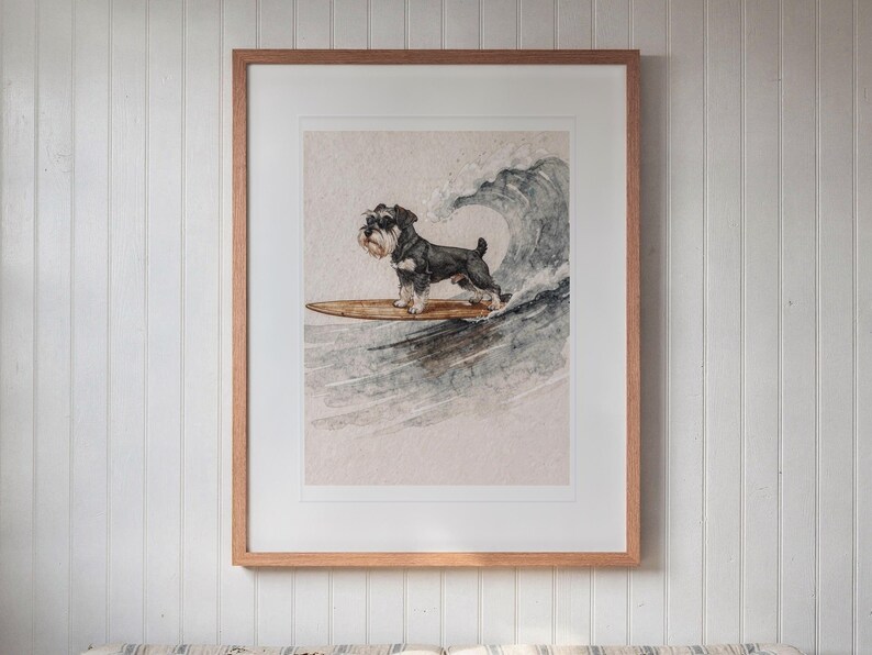 Miniature Schnauzer Surfing printable art, shown printed in a Red Oak frame with a white mat, hanging above the bench in a breakfast nook.