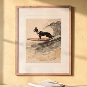 Black and White Surfing Dog print in a Red Oak frame with a white mat, hanging above the bench in a breakfast nook.