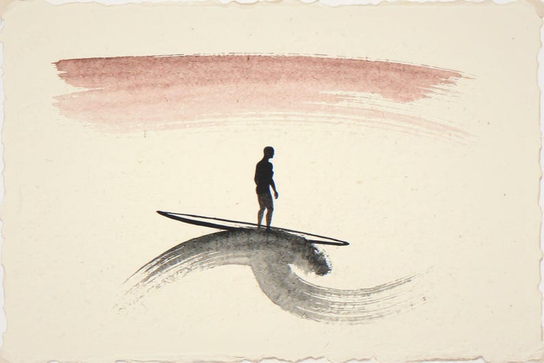 Sumi-e Lone Surfer with Rose Dawn Accent Print framed in a modern bedroom setting