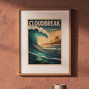 Cloudbreak Fiji Surf Poster printable art, shown printed in a Red Oak frame with a white mat, hanging above the table in a boho living room.