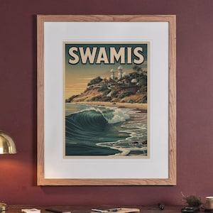 Swamis Surf Travel Poster print in a Red Oak frame with a white mat, hanging above the sideboard in a green study.
