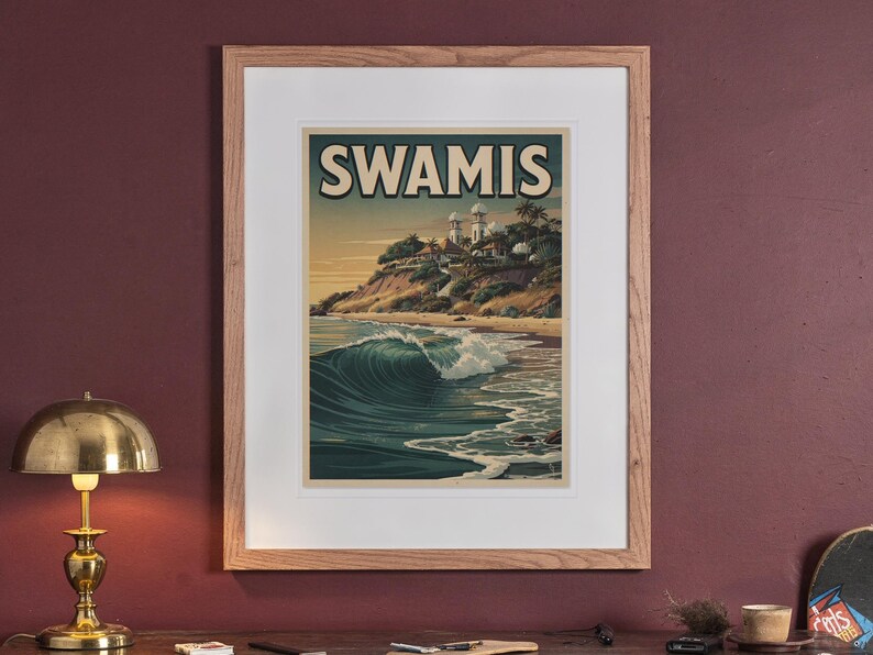 Swamis Surf Travel Poster print in a Red Oak frame with a white mat, hanging above the sideboard in a green study.
