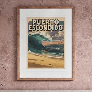 Puerto Escondido Surf Travel Poster print in a Red Oak frame with a white mat, hanging above the headboard in a calm bedroom.