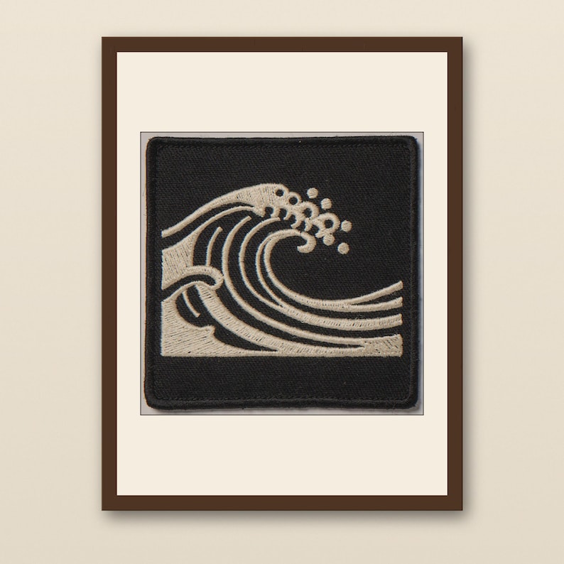 Wave Embroidered Patch Print - walnut framed art print with cream mat on plaster wall