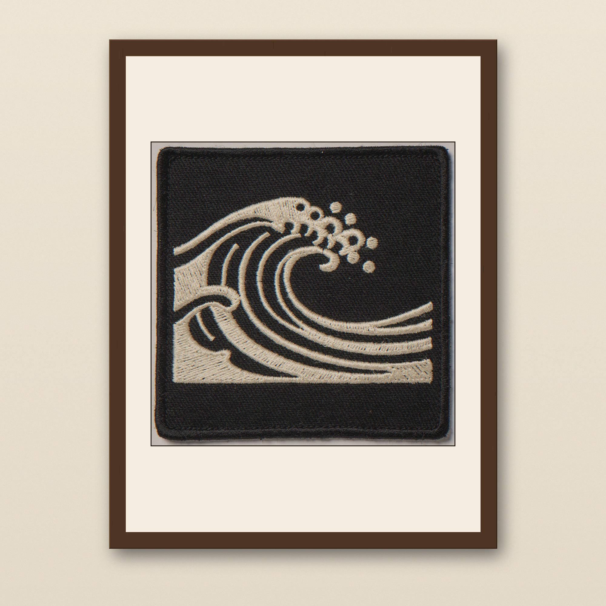Wave Embroidered Patch Print - walnut framed art print with cream mat on plaster wall
