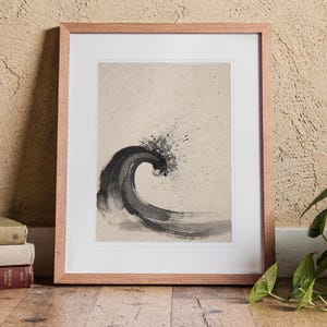 Curling Wave Ink Style print in a Red Oak frame with a white mat, standing on the floor, leaning back slightly against the wall in a living room floor lean.
