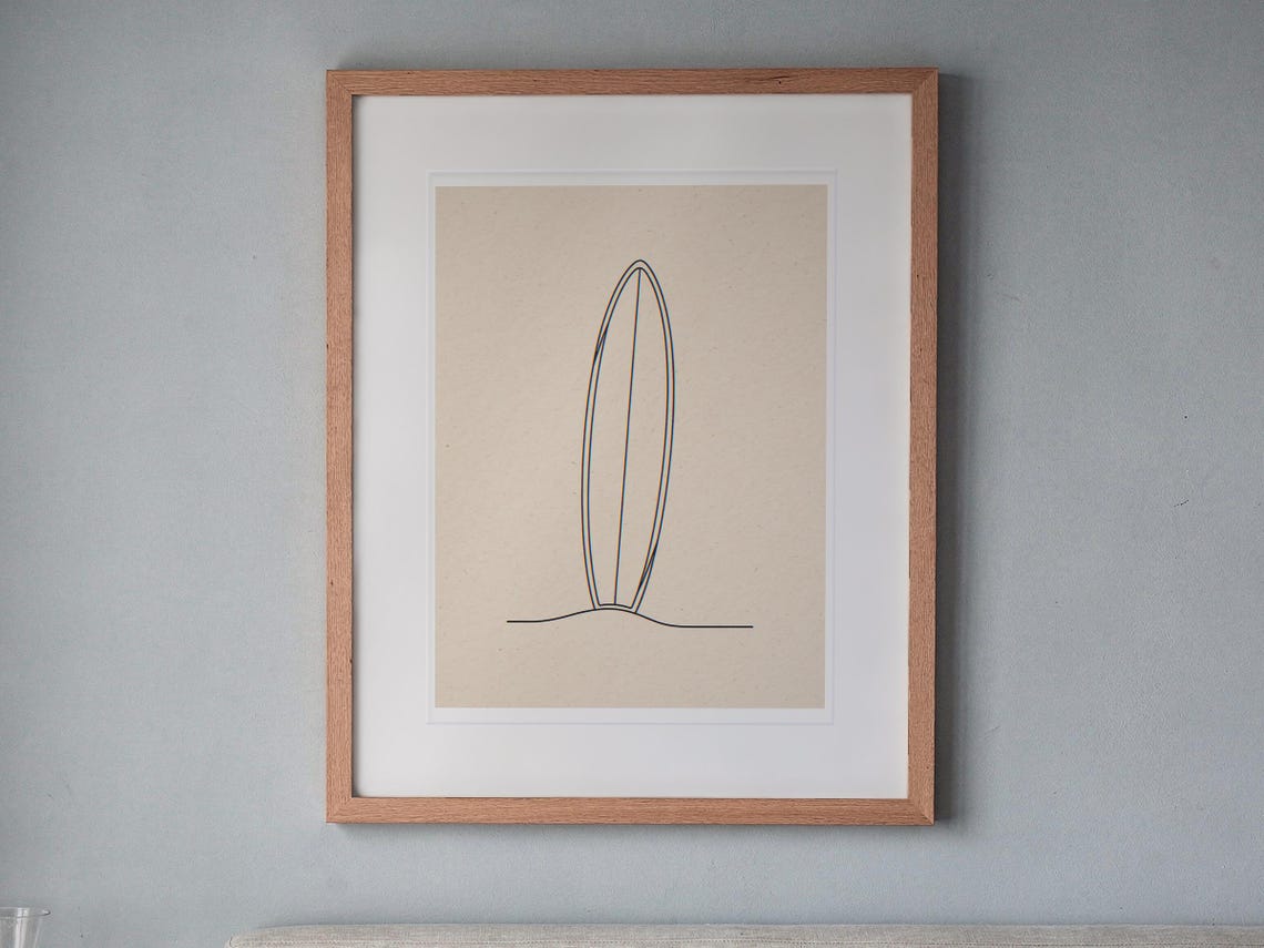 Boho Longboard Line Art printable art, shown printed in a Red Oak frame with a white mat, hanging above the headboard in a calm bedroom.