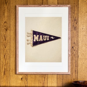 Maui Surf Pennant print in a Red Oak frame with a white mat, hanging above the sideboard in a mid-century living room.