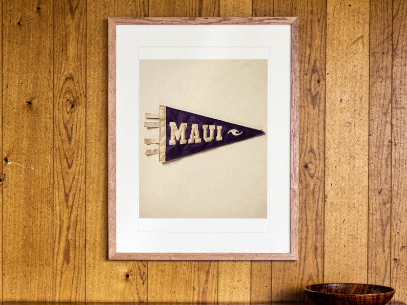 Maui Surf Pennant print in a Red Oak frame with a white mat, hanging above the sideboard in a mid-century living room.