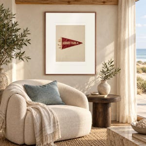 Asbury Park Surf Pennant print in a Red Oak frame with a white mat in a light-filled coastal sitting room.