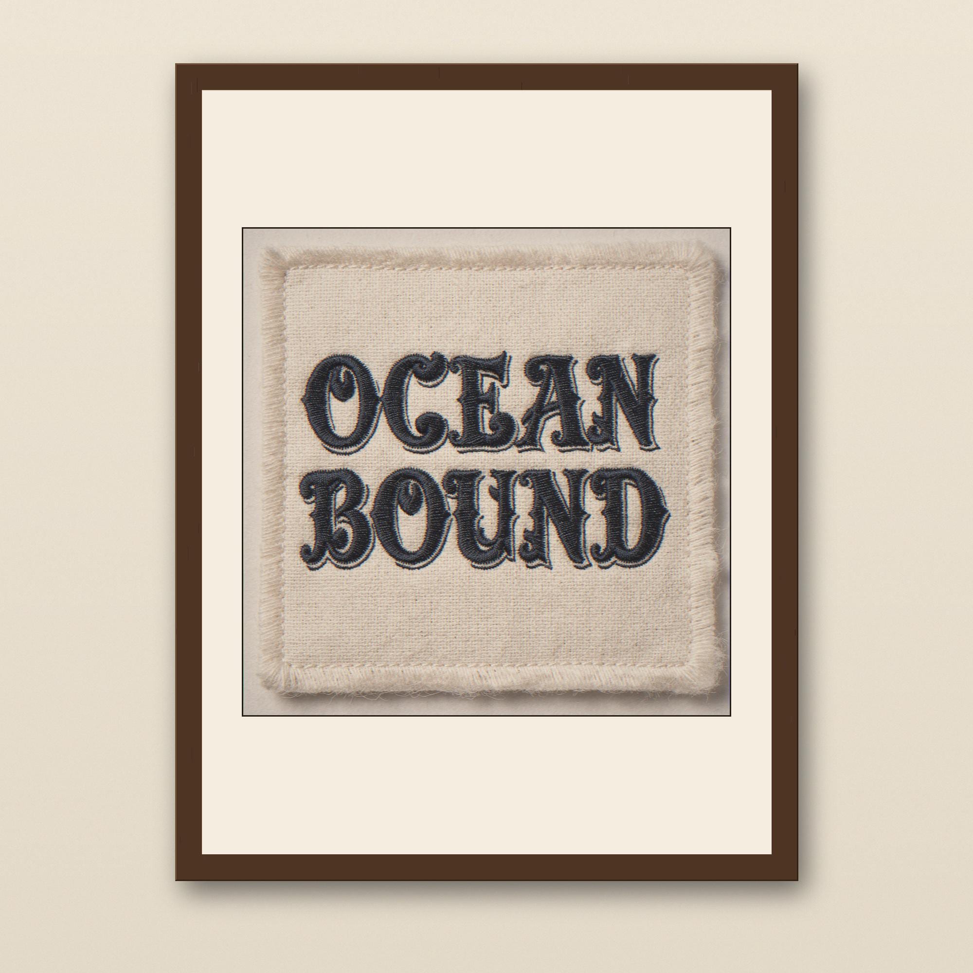 Ocean Bound Embroidered Patch Print - walnut framed art print with cream mat on plaster wall