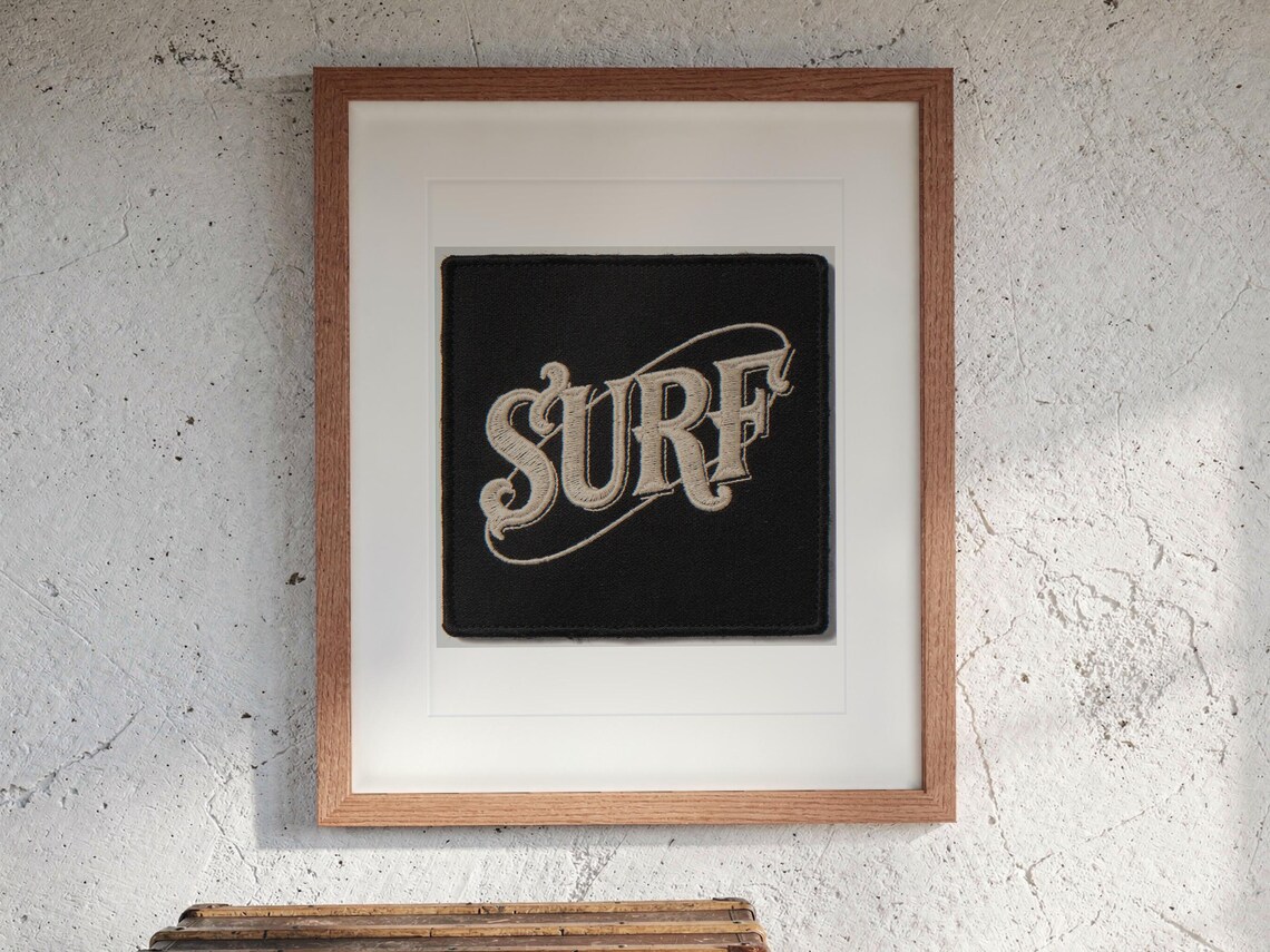 Surf Patch print in a Red Oak frame with a white mat, hanging above the trunk in a beach house loft.