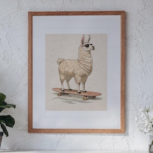 May include: A framed wall art print featuring a light-colored llama wearing black sunglasses while standing on a wooden skateboard. The illustration is set against a neutral, textured background and enclosed in a simple light wood frame.