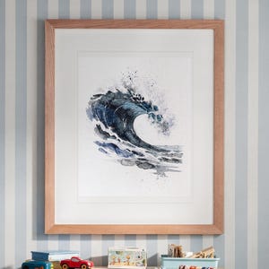 May include: A framed watercolor painting of a dark blue ocean wave crashing. The artwork is set within a light-toned wooden frame with a white mat board. The wave features deep indigo and navy blue tones with white foam and paint splatters.