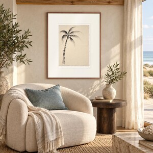 Lone Palm Tree Ink Style print in a Red Oak frame with a white mat in a light-filled coastal sitting room.