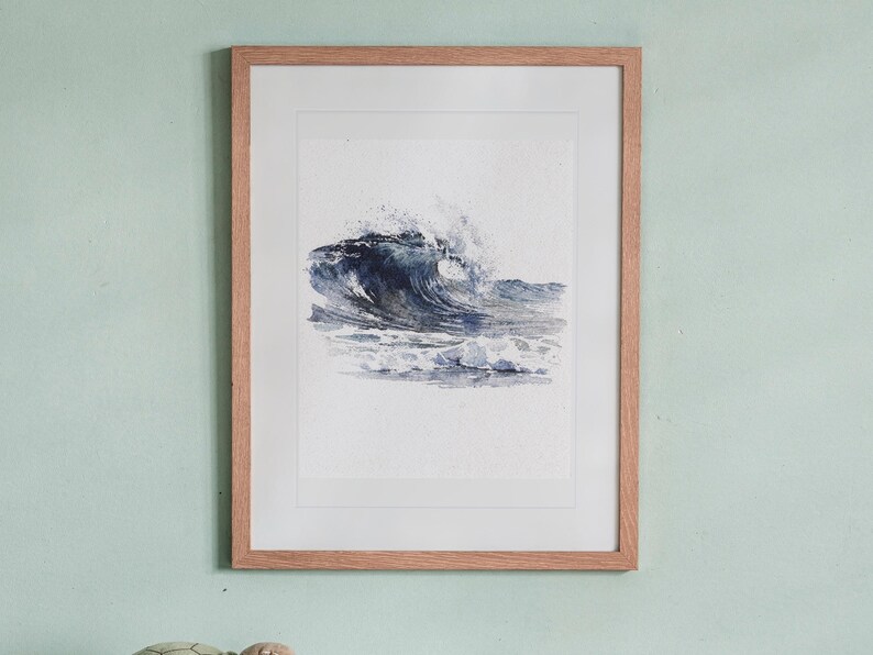 Rolling Break Wave Watercolor print in a Red Oak frame with a white mat, hanging above the bookshelf in a kids' room.