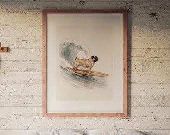 May include: A framed wall art print featuring a tan pug with a black face standing on a wooden surfboard. The dog is positioned in front of a large, crashing blue and white ocean wave, rendered in a watercolour style within a light wood frame.