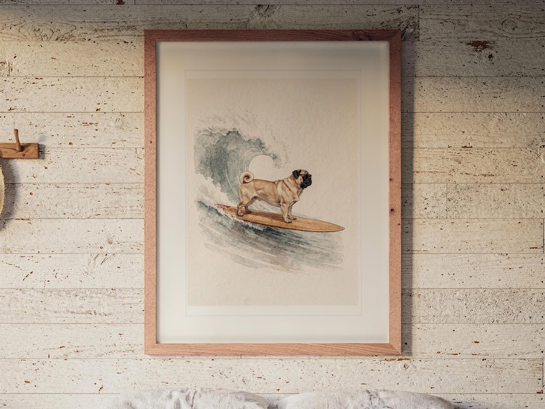Pug Surfing print in a Red Oak frame with a white mat, hanging above the bed in a surf shack bedroom.