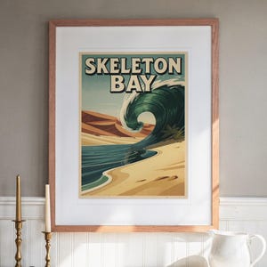 Skeleton Bay Namibia Surf Travel Poster print in a Red Oak frame with a white mat, hanging above the buffet in a dining room.