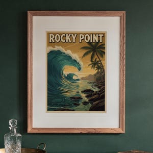 Rocky Point Surf Travel Poster print in a Red Oak frame with a white mat, hanging above the sideboard in a green study.