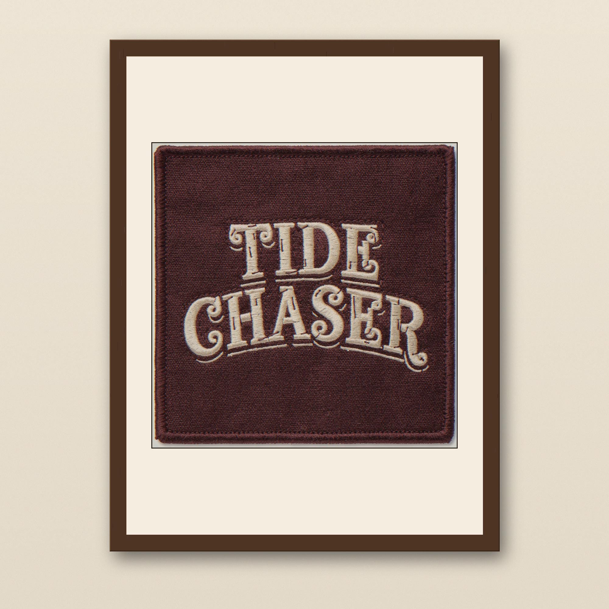 Tide Chaser Embroidered Patch Print - walnut framed art print with cream mat on plaster wall