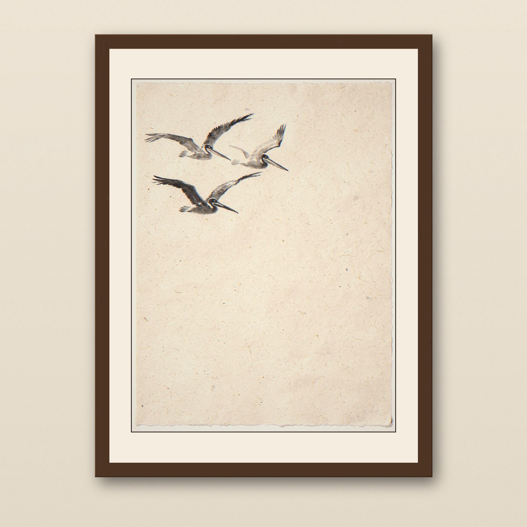 Sumi-e Three Pelicans Print - walnut framed art print with cream mat on plaster wall