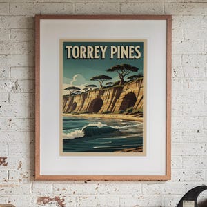 Torrey Pines Surf Travel Poster print in a Red Oak frame with a white mat, hanging above the workbench in a surf garage.