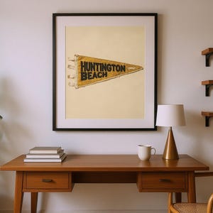 Huntington Beach Vintage Surf Pennant Print framed in a home office setting