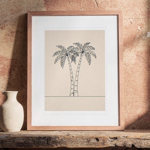 Palm Tree Line print in a Red Oak frame with a white mat, leaning on the bench against the wall in a boho living room.