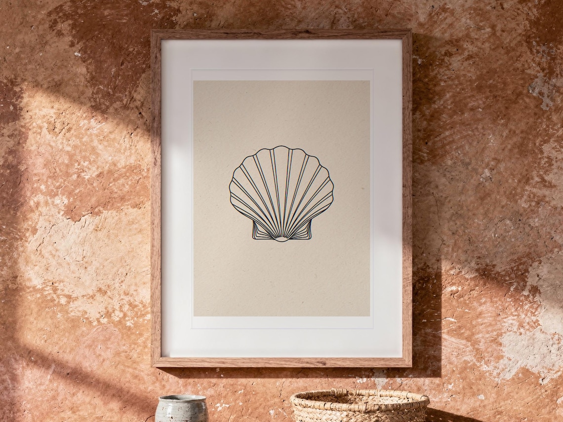 Seashell Line print in a Red Oak frame with a white mat, hanging above the table in a boho living room.