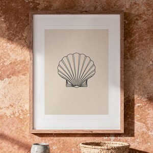 Seashell Line print in a Red Oak frame with a white mat, hanging above the table in a boho living room.