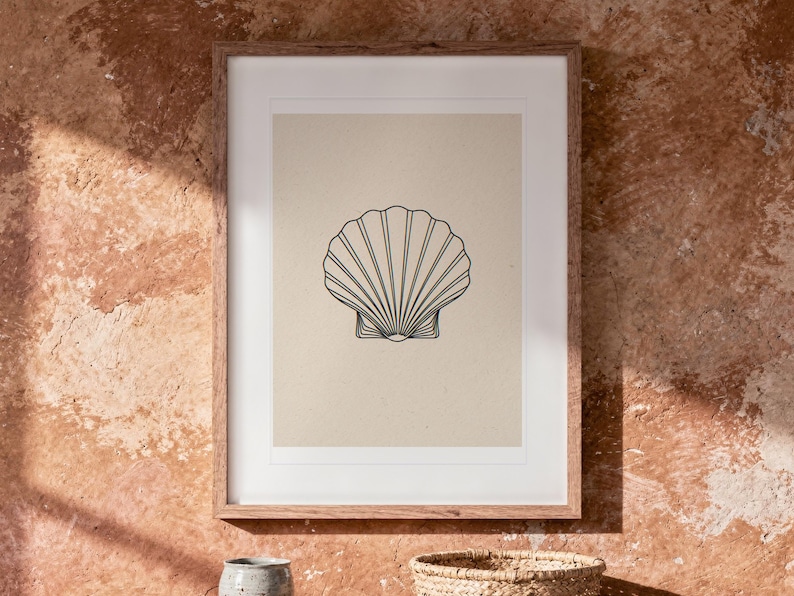 Seashell Line print in a Red Oak frame with a white mat, hanging above the table in a boho living room.