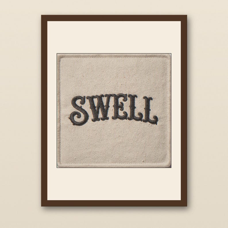 Swell Embroidered Patch Print - walnut framed art print with cream mat on plaster wall