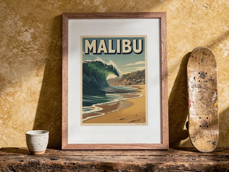Malibu Surf Travel Poster print in a Red Oak frame with a white mat, leaning on the bench against the wall in a boho living room.
