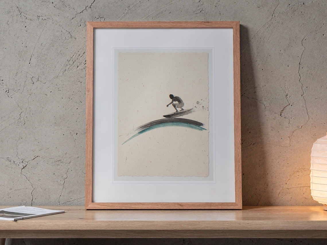 Surf Shack Decor printable art, shown printed in a Red Oak frame with a white mat, leaning on the bench against the wall in a japandi living room.