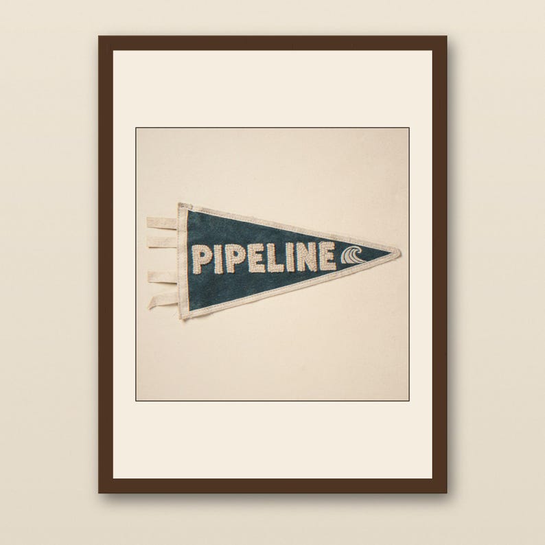 Pipeline Vintage Surf Pennant Print - walnut framed art print with cream mat on plaster wall