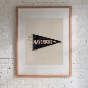 Mavericks Surf Pennant print in a Red Oak frame with a white mat, hanging above the bench in a mudroom.